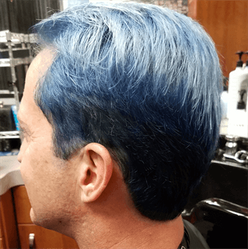 A customer with a bright blue haircut