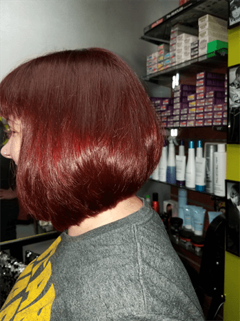 A customer with a dark red haircut