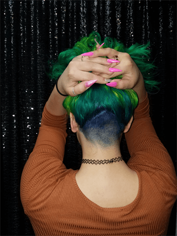 A customer with a green and blue haircut