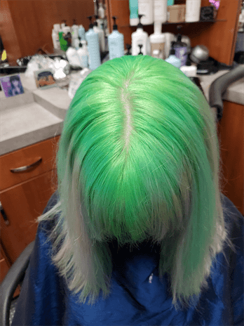 A customer with a green ombre haircut