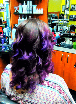 A customer with a long black and purple haircut