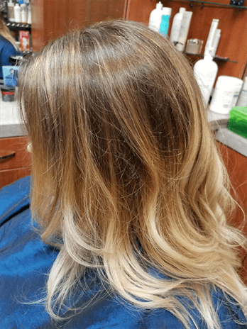 A customer with a long blonde haircut