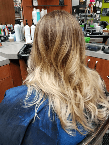 A customer with a long blonde haircut