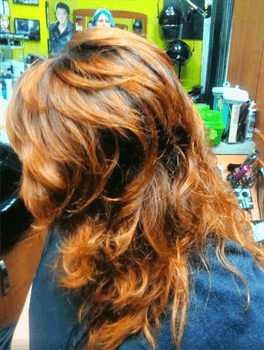 A customer with a long light brown haircut