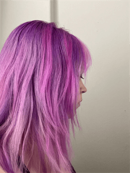 A customer with a long pink haircut