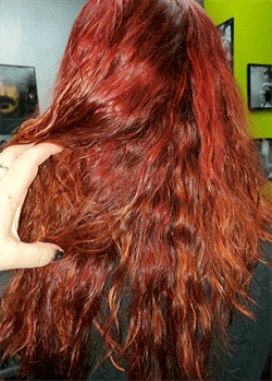 A customer with a long red haircut