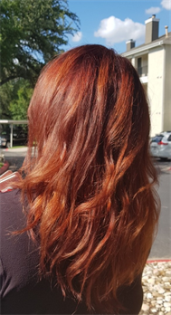 A customer with a long red haircut