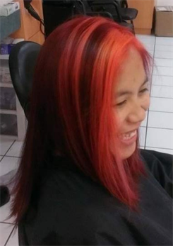 A customer with a long red ombre haircut