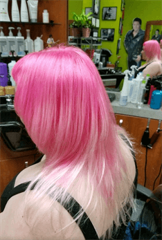 A customer with a pink and blonde haircut