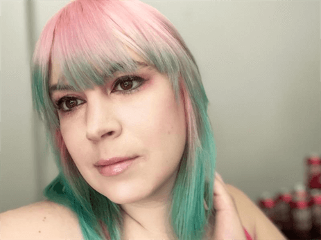 A customer with a pink and green haircut