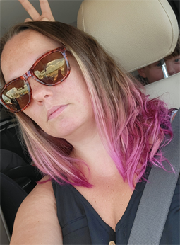 A customer with a pink ombre haircut