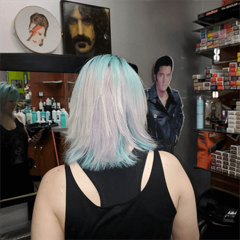 A customer with a platinum rainbow haircut