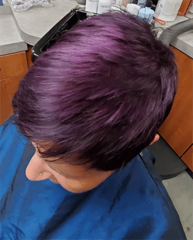 A customer with a purple haircut