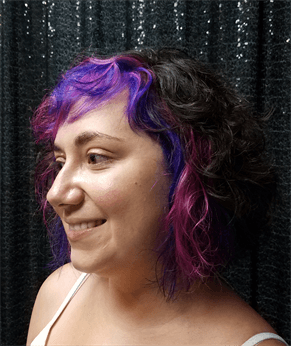 A customer with a purple ombre haircut