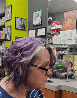 A customer with a short purple haircut