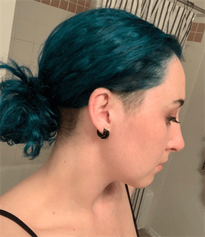 A customer with a turquoise haircut